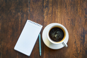 coffee and notepad and pen on a table